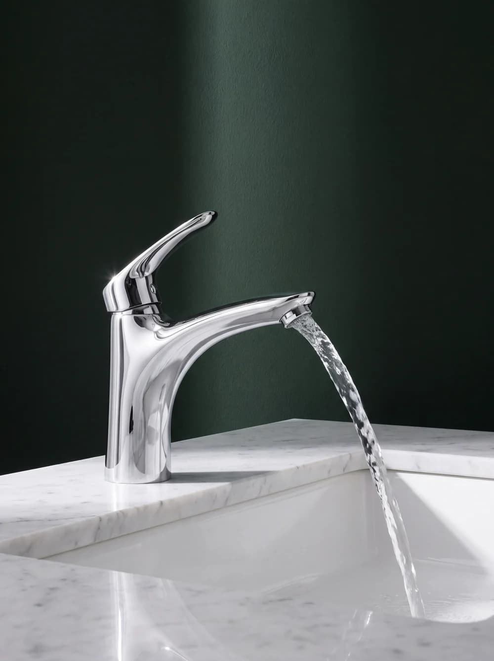 Chrome basin mixer running over marble